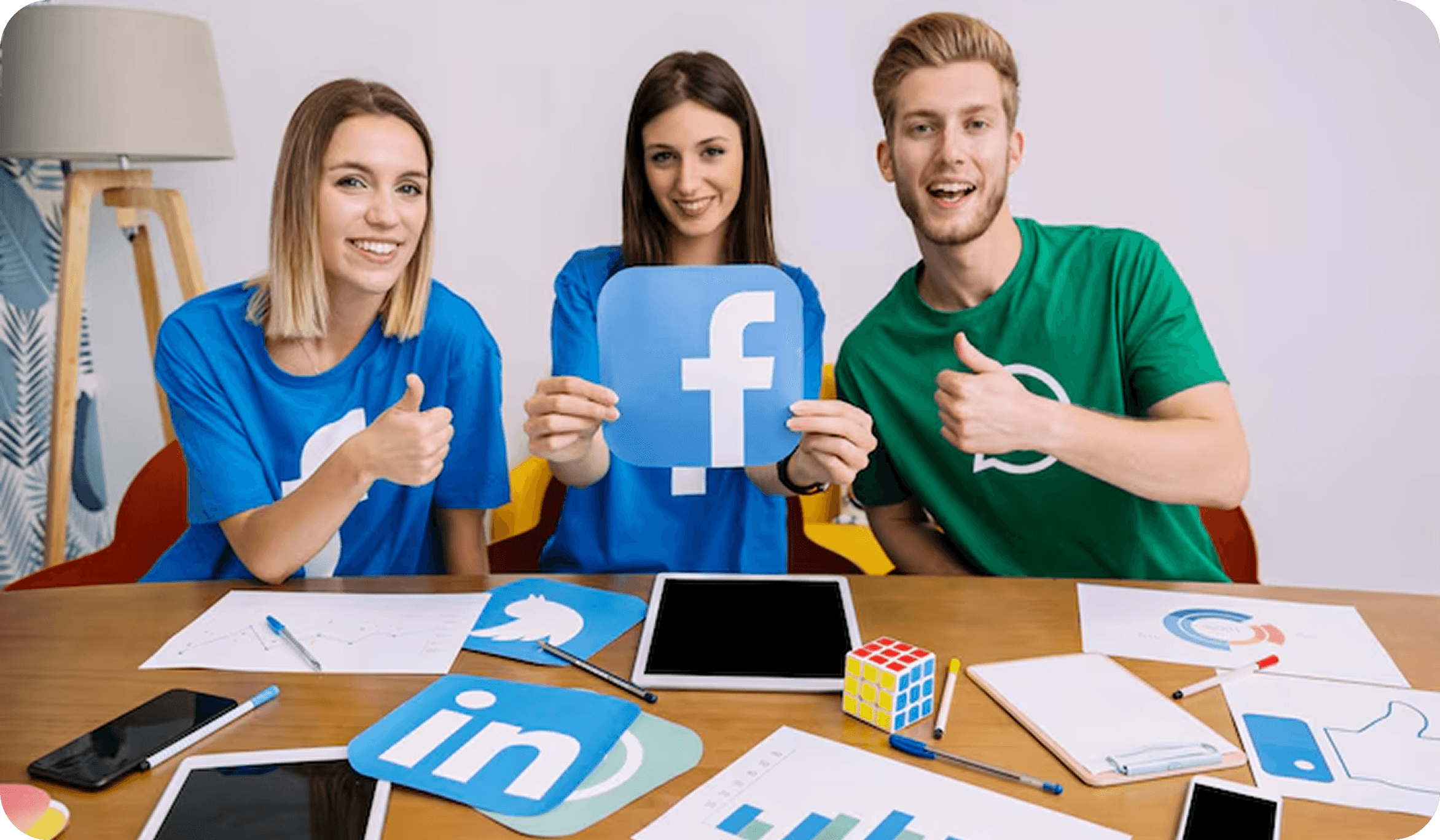 Team holding Facebook icons